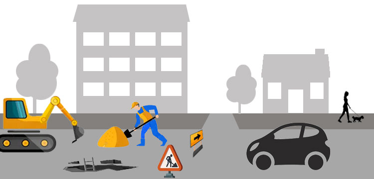 Un ouvrier travaille sur une route, entouré d'une voiture et d'équipements de construction.